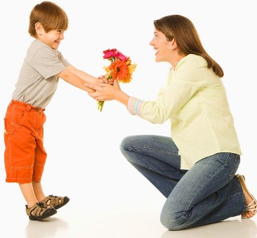 Bimbo che regala i fiori alla propria mamma
